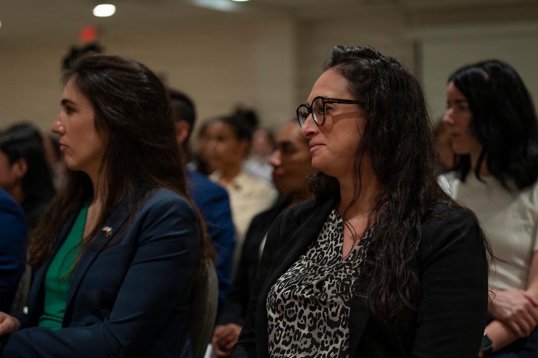 U.S. Air Force Reserve Lt. Col Emily De Leon, right, listens to remarks during the Lesser Antilles Medical Assistance Team (LAMAT) 2026 closing ceremony in Frigate Bay, Saint Kitts and Nevis, March 7, 2026. The ceremony marked the conclusion of a two-week medical engagement that brought U.S. Air Force personnel and Ministry of Health providers together across St. Kitts and Nevis. (U.S. Air Force photo by Andrea Jenkins)