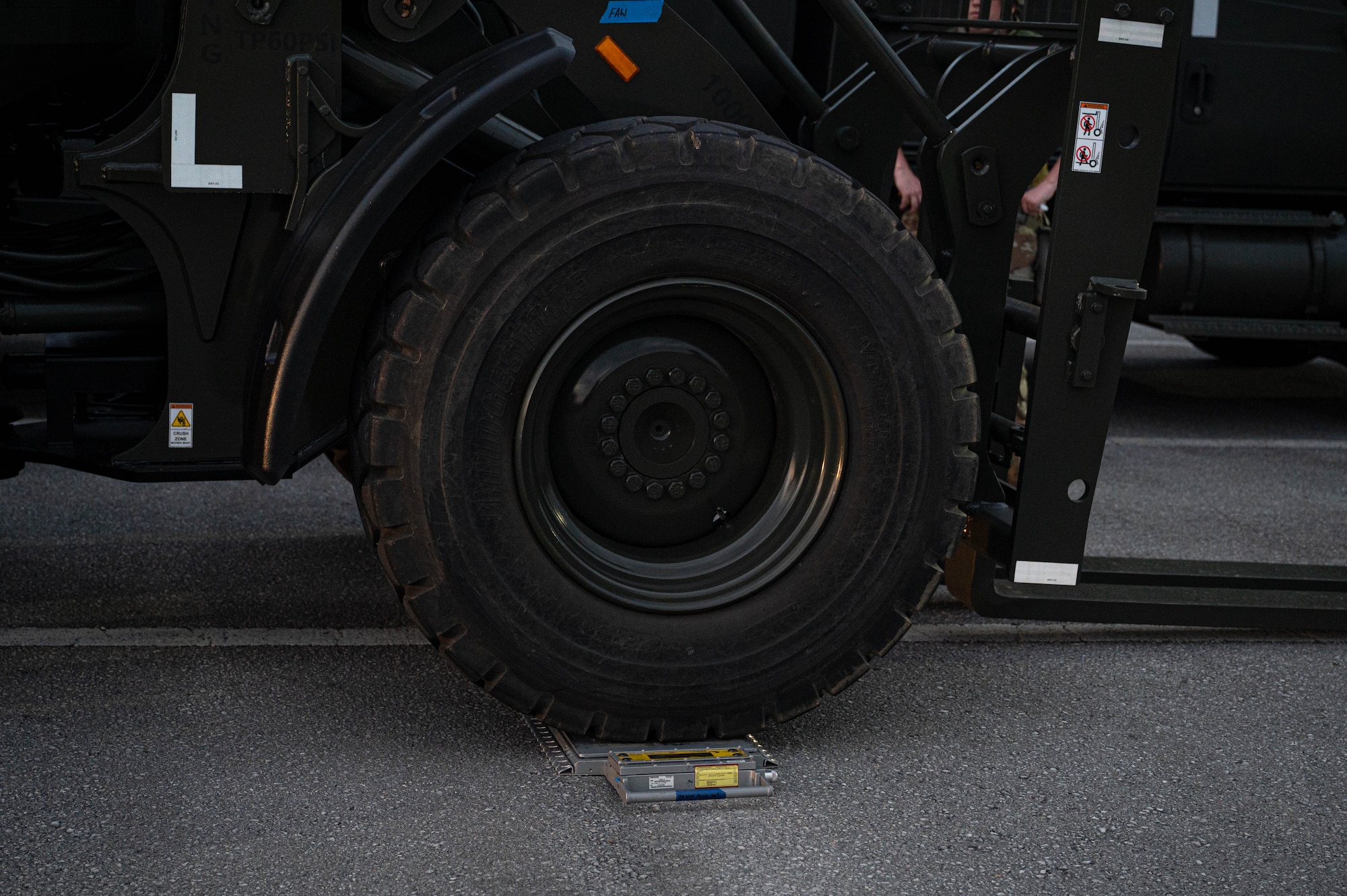 A forklift drives over a portable, compact, industrial scale during U.S. Air Force -led operational exercise Beverly Midnight 26 at Kadena Air Base, Japan, Mar. 10, 2026. BM26 provides unique opportunities to synchronize and integrate various forces across Japan into joint, coalition and bilateral training from simulated forward operating bases. (U.S. Air Force photo by Senior Airman Jamal J. Berry II)