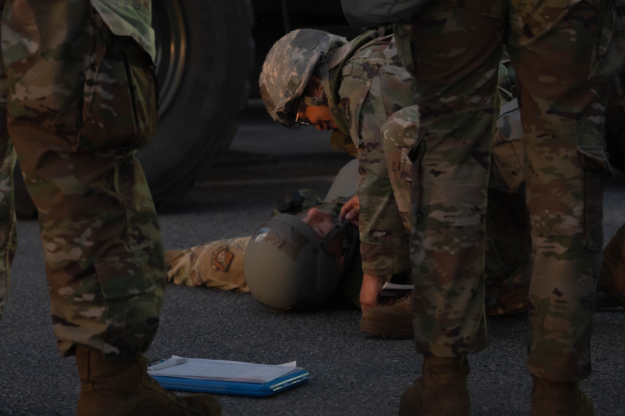 U.S. Air Force Airman Estrella Aguilar, 18th Ground Transportation forklift operator, checks for blocked airways on SrA Leonel Murillo, 18th Traffic Management Office technician, who is simulated to be injured in a simulated work-related accident during USAF-led operational exercise Beverly Midnight 26 at Kadena Air Base, Japan, Mar. 10, 2026. Realistic combat training is essential to the success of air and space operations. (U.S. Air Force photo by Senior Airman Jamal J. Berry II)