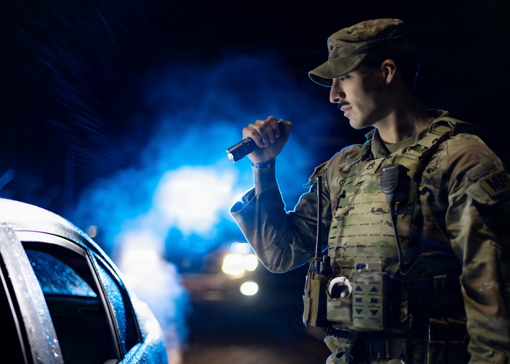Staff Sgt. Victor Garza, a military police officer assigned to the 92nd Military Police Company, questions a suspected impaired driver during a traffic stop.