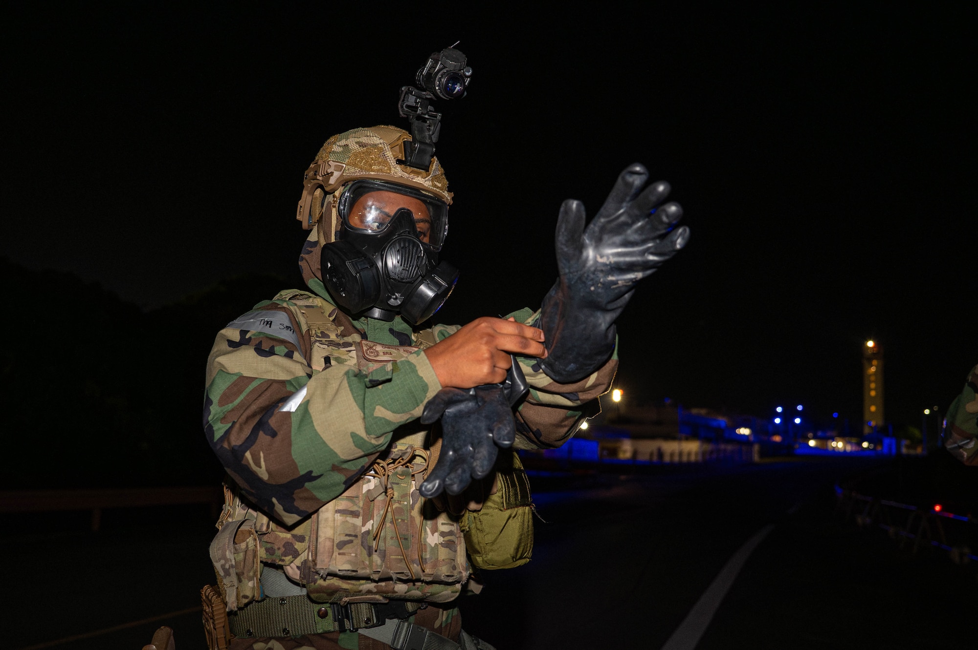 U.S. Air Force Senior Airman Chenya Henley, 18th Security Forces Squadron law enforcement patrolman, response force member, dawns her glove during a USAF-led operational exercise Beverly Midnight 26 at Kadena Air Base, Japan, March 12, 2026. BM26 challenges U.S. forces across Japan with realistic training scenarios that sharpen decision-making and strengthen overall operational readiness. (U.S. Air Force photo by Airman 1st Class Nathaniel Jackson)