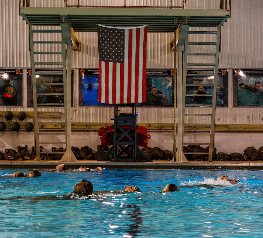 U.S. Marines perform water rescue swims during the Water Survival Advanced Course at Ramer Hall on Marine Corps Base Quantico, Virginia, Jan. 22, 2026. The week-long Water Survival Advanced course challenges Marines’ physical and mental limits through aquatic endurance training, including long swims, breath holds, and complex rescue drills vital to amphibious operations. (U.S. Marine Corps photo by Lance Cpl. Donovan E. Melendez)
