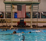 U.S. Marines perform water rescue swims during the Water Survival Advanced Course at Ramer Hall on Marine Corps Base Quantico, Virginia, Jan. 22, 2026. The week-long Water Survival Advanced course challenges Marines’ physical and mental limits through aquatic endurance training, including long swims, breath holds, and complex rescue drills vital to amphibious operations. (U.S. Marine Corps photo by Lance Cpl. Donovan E. Melendez)