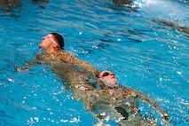 U.S. Marines perform water rescue swims during the Water Survival Advanced Course at Ramer Hall on Marine Corps Base Quantico, Virginia, Jan. 22, 2026. The week-long Water Survival Advanced course challenges Marines’ physical and mental limits through aquatic endurance training, including long swims, breath holds, and complex rescue drills vital to amphibious operations. (U.S. Marine Corps photo by Lance Cpl. Donovan E. Melendez)