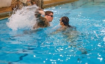 U.S. Marine Corps Sgt. John J. Davis, left, a Marine Corps Instructor of Water Survival with The Basic School, acts as a simulated victim for Cpl. Lizette M. Baez, an intelligence specialist with the Marine Corps intelligence Activity, during a water rescue swim for the Water Survival Advanced Course at Ramer Hall on Marine Corps Base Quantico, Virgicnia, Jan. 22, 2026. The week-long Water Survival Advanced ourse challenges Marines’ physical and mental limits through aquatic endurance training, including long swims, breath holds, and complex rescue drills vital to amphibious operations. (U.S. Marine Corps photo by Lance Cpl. Donovan E. Melendez)