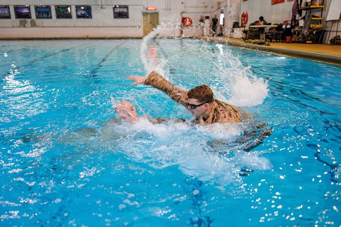 U.S. Marine Corps Sgt. John J. Davis, right, a Marine Corps Instructor of Water Survival with The Basic School, acts as a simulated victim for 2nd Lt. Grant A. Wernick, a student with The Basic School, during a water rescue swim for the Water Survival Advanced Course at Ramer Hall on Marine Corps Base Quantico, Virginia, Jan. 22, 2026. The week-long Water Survival Advanced course challenges Marines’ physical and mental limits through aquatic endurance training, including long swims, breath holds, and complex rescue drills vital to amphibious operations. (U.S. Marine Corps photo by Lance Cpl. Donovan E. Melendez)