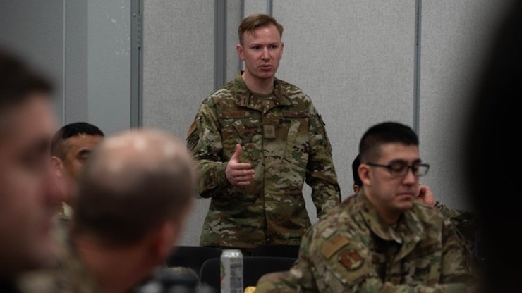U.S. Air Force Tech. Sgt. Author Rifenbury, 5th Maintenence Squadron crew chief, asks a question during the First Sergeant Symposium at Minot Air Force Base, North Dakota, Feb. 23, 2024. The First Sergeant Symposium allowed Minot Airmen to gain valuable tools and resources needed to step into the role of a first sergeant.