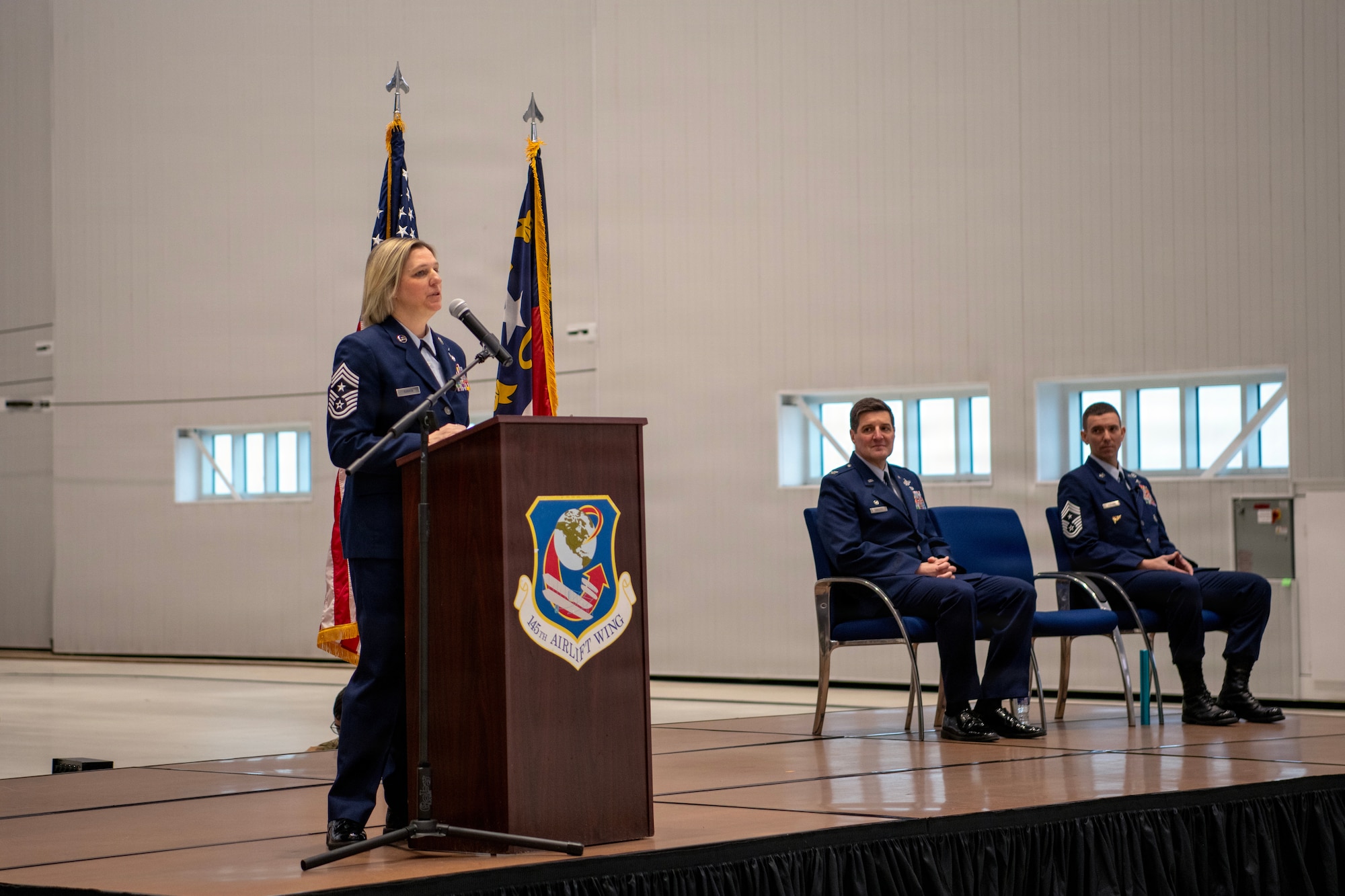 U.S. Air Force Chief Master Sgt. Tracie B. Rankin, left, gives her first speech as the 145th Airlift Wing command chief as Col. Marshal T. Haylett, 145th AW commander, middle, and Chief Master Sgt. Jeremy S. Mullins, outgoing 145th AW command chief listen, during the change of responsibility ceremony held at the Charlotte Air National Guard base, Feb. 27, 2026.