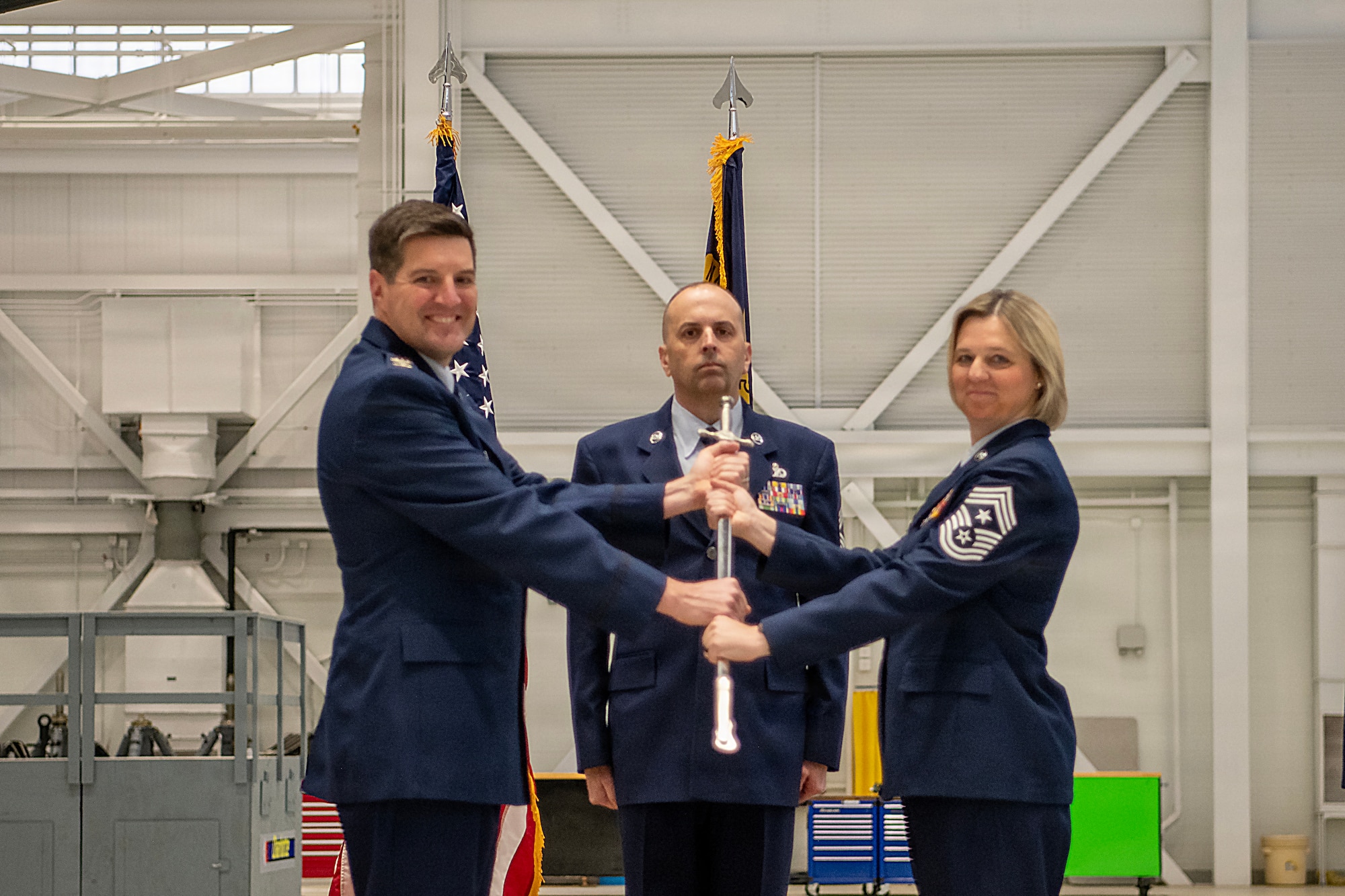 U.S. Air Force Col. Marshal T. Haylett, 145th Airlift Wing (AW) commander, left, presents a ceremonial sword to Chief Master Sgt. Tracie B. Rankin, incoming 145th AW command chief, right, as she assumes responsibility as the 145th AW command chief at a change of responsibility ceremony held at the Charlotte Air National Guard base, Feb. 27, 2026.