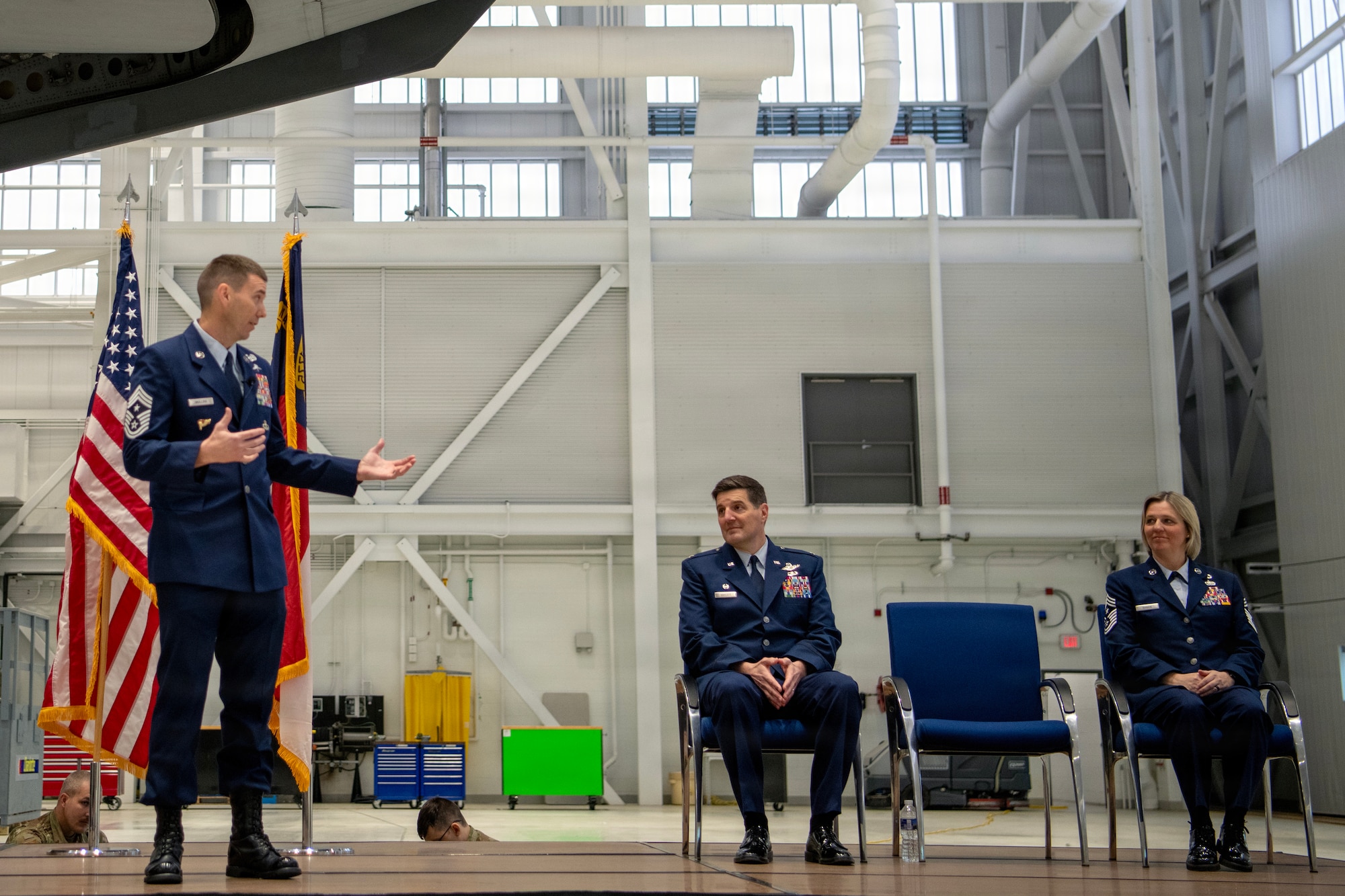 U.S. Air Force Chief Master Sgt. Jeremy S. Mullins, 145th Airlift Wing (AW) outgoing command chief, left, gives a speech as Col. Marshal T. Haylett, 145th AW commander, middle, and Chief Master Sgt. Tracie B. Rankin, 145th AW incoming command chief, listen during a change of responsibility ceremony held at the Charlotte Air National Guard base, Feb. 27, 2026.