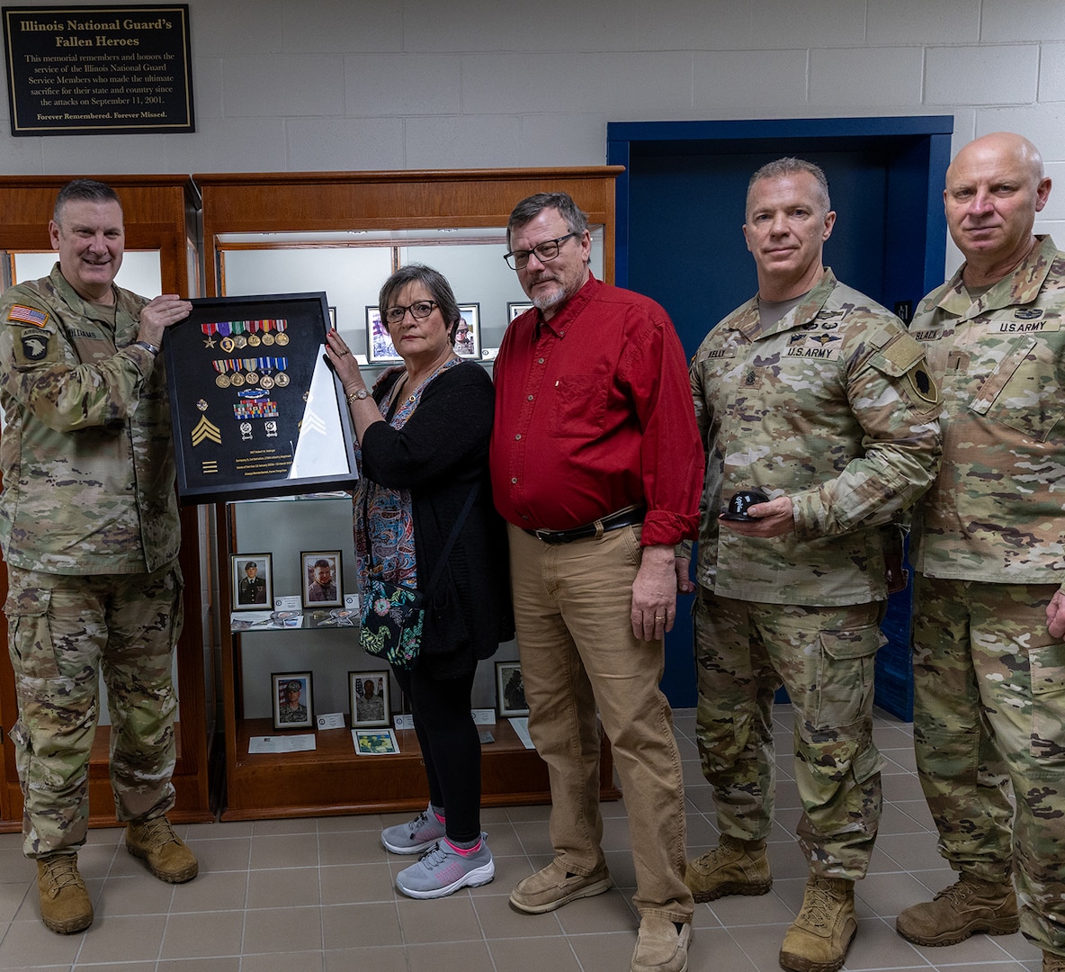 Brig. Gen. Lenny Williams, Assistant Adjutant General – Army and Commander of the Illinois Army National Guard, presents Sue King-Wieczorek, Gold Star mother of U.S. Army Sgt. Robert M. Weinger, with a shadow box containing Weinger’s medals he earned during his military service in the Illinois Army National Guard.