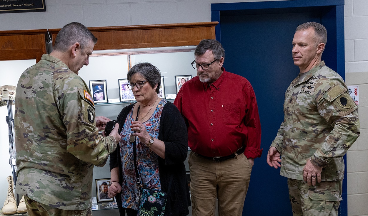 Brig. Gen. Lenny Williams, Assistant Adjutant General – Army and Commander of the Illinois Army National Guard, presents Sue King-Wieczorek with a Chicago White Sox mini helmet to include in the memorial case at the Illinois Military Academy on Camp Lincoln in Springfield.