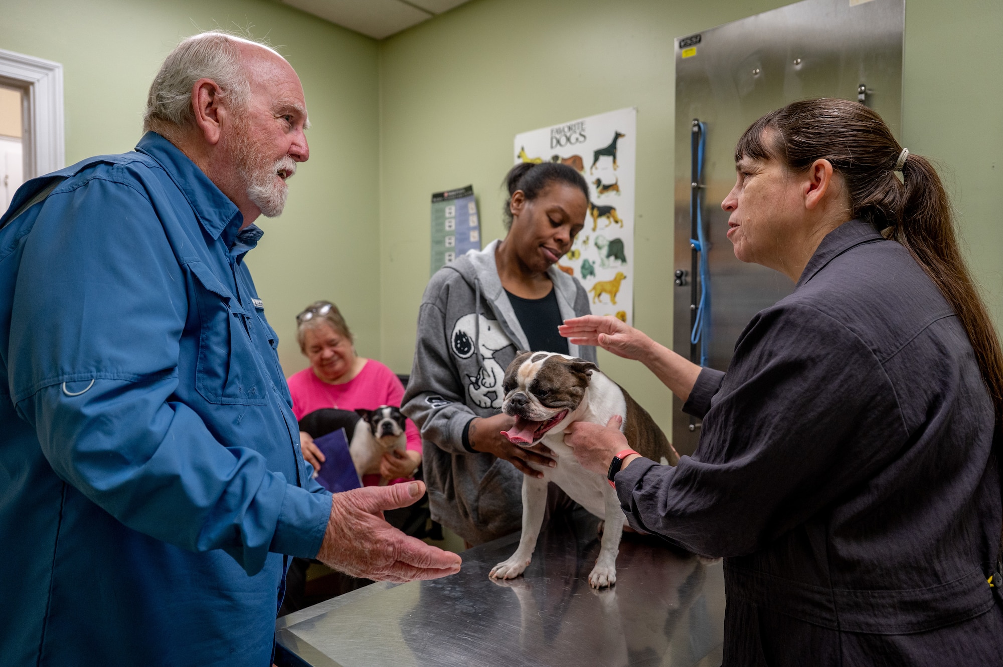 A Maxwell Air Force Base veterinarian discusses patient information with the pet's owner.