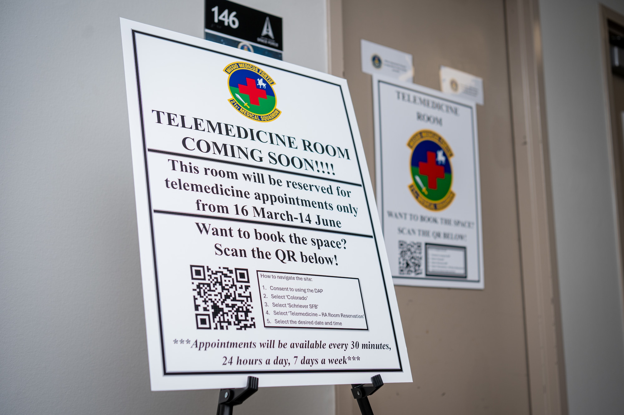 A sign announcing the Telehealth Room pilot program is displayed in the hallway at Schriever Space Force Base
