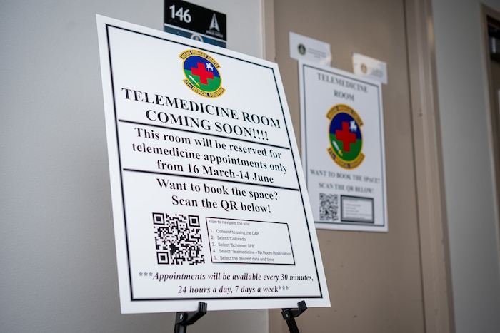 A sign announcing the Telehealth Room pilot program is displayed in the hallway at Schriever Space Force Base