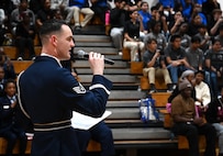 U.S. Air Force Staff Sgt. William Douglas, ceremonial guardsman with the U.S. Air Force Honor Guard Drill Team, emcees a performance during a visit to Ronald McNair Sr. High School in Atlanta, Ga., March 11, 2026. During the event, the Drill Team worked with local recruiters and high schools to emphasize the Air Force mission and inspire the future generation of service members. (U.S. Air Force photo by Tech. Sgt. Sergio A. Gamboa)