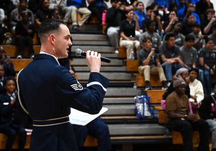 U.S. Air Force Staff Sgt. William Douglas, ceremonial guardsman with the U.S. Air Force Honor Guard Drill Team, emcees a performance during a visit to Ronald McNair Sr. High School in Atlanta, Ga., March 11, 2026. During the event, the Drill Team worked with local recruiters and high schools to emphasize the Air Force mission and inspire the future generation of service members. (U.S. Air Force photo by Tech. Sgt. Sergio A. Gamboa)