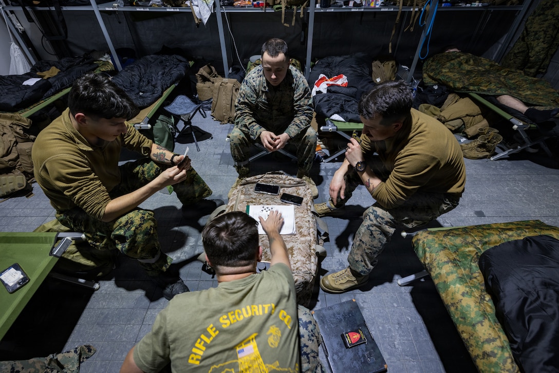 U.S. Marines with 6th Engineer Support Battalion, 4th Marine Logistics Group, Marine Forces Reserve, play a card game in Elvegårdsmoen, Norway, Feb. 11, 2026. The Marines took a break from their duties while deployed in preparation for exercise Cold Response 26. A key component of NATO's enhanced vigilance activity Arctic Sentry, exercise Cold Response 26 is a Norwegian-led winter military exercise designed to enhance collective defense capabilities and ensure U.S. readiness to rapidly deploy and seamlessly operate alongside NATO Allies in challenging arctic conditions. (U.S. Marine Corps photo by Staff Sgt. Scott Jenkins)