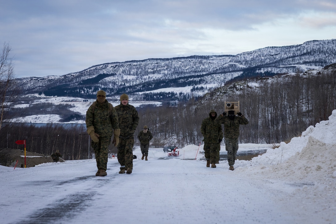 U.S. Marines with 6th Engineer Support Battalion, 4th Marine Logistics Group, Marine Forces Reserve, carry bulk fuel equipment up a hill in Elvegårdsmoen, Norway, Feb. 26, 2026. The Marines were staging the equipment in preparation for exercise Cold Response 26. A key component of NATO's enhanced vigilance activity Arctic Sentry, exercise Cold Response 26 is a Norwegian-led winter military exercise designed to enhance collective defense capabilities and ensure U.S. readiness to rapidly deploy and seamlessly operate alongside NATO Allies in challenging arctic conditions. (U.S. Marine Corps photo by Staff Sgt. Scott Jenkins)