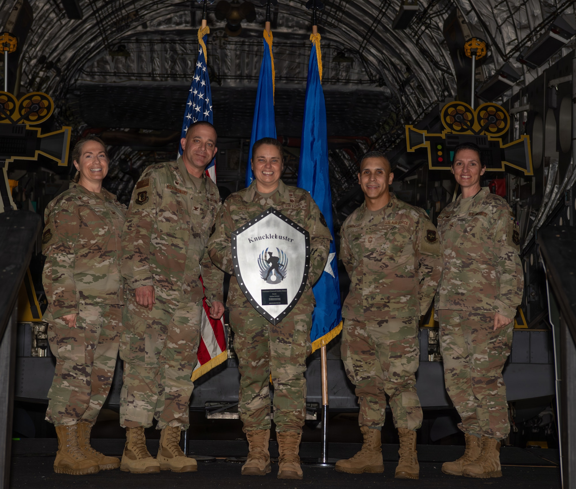 Leadership present a plaque to distinguished guest speaker, Lt. Gen. Linda Hurry, commander of Air Force Materiel Command, during the 5th Annual Knucklebuster Awards ceremony.