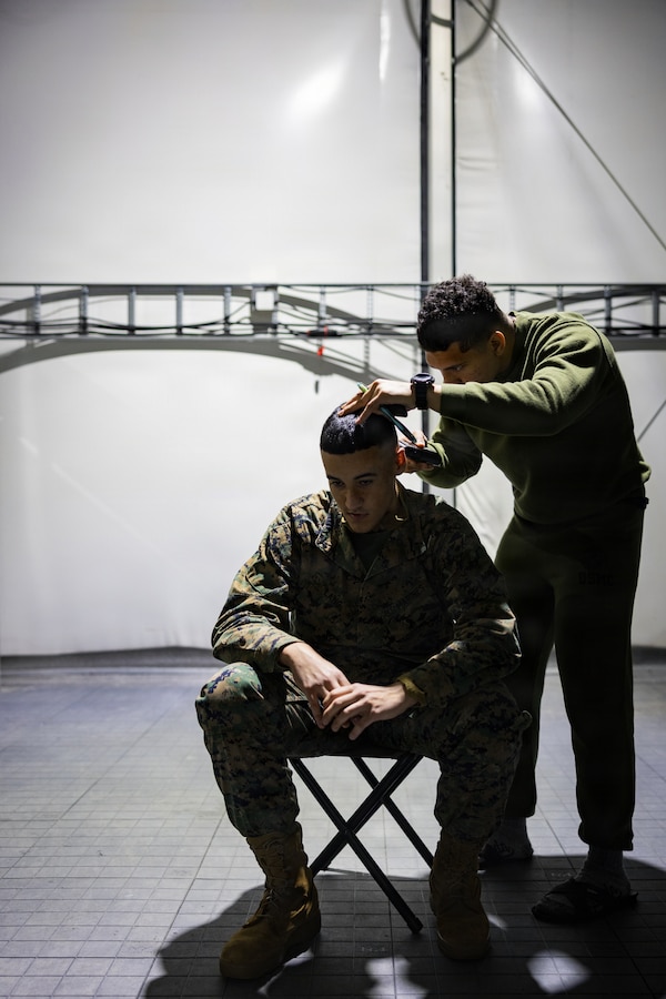 U.S. Marine Corps Lance Cpl. Caleb Lang, left, receives a haircut from Cpl. Nicholas Guzman, both expeditionary fuels technicians with 6th Engineer Support Battalion, 4th Marine Logistics Group, Marine Forces Reserve, in Elvegårdsmoen, Norway, Feb. 22, 2026. The Marines were deployed to Norway in preparation for exercise Cold Response 26. A key component of NATO's enhanced vigilance activity Arctic Sentry, exercise Cold Response 26 is a Norwegian-led winter military exercise designed to enhance collective defense capabilities and ensure U.S. readiness to rapidly deploy and seamlessly operate alongside NATO Allies in challenging arctic conditions. (U.S. Marine Corps photo by Staff Sgt. Scott Jenkins)