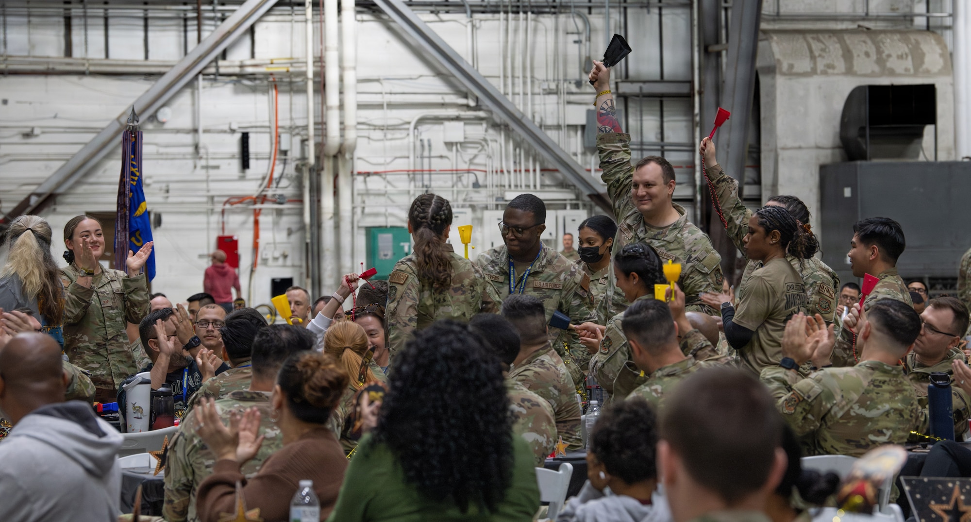 A team of maintainers from the 437th Maintenance Group cheer for the winners of the 5th annual Knucklebuster Awards ceremony.