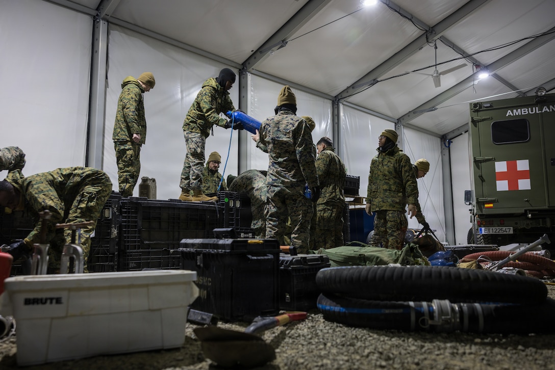 U.S. Marines with 6th Engineer Support Battalion, 4th Marine Logistics Group, Marine Forces Reserve, unpack bulk fuel equipment in Elvegårdsmoen, Norway, Feb. 25, 2026. The equipment was unpacked in preparation for exercise Cold Response 26. A key component of NATO's enhanced vigilance activity Arctic Sentry, exercise Cold Response 26 is a Norwegian-led winter military exercise designed to enhance collective defense capabilities and ensure U.S. readiness to rapidly deploy and seamlessly operate alongside NATO Allies in challenging arctic conditions. (U.S. Marine Corps photo by Staff Sgt. Scott Jenkins)