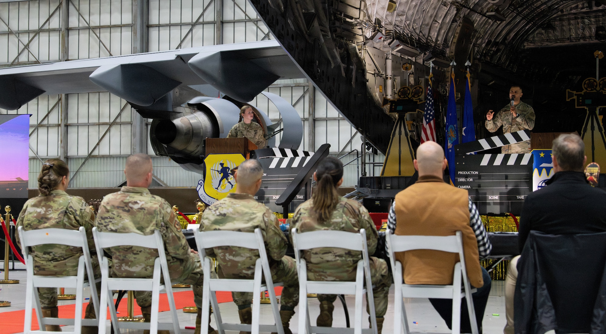 U.S. Air Force Senior Airman Josephus Tolbert, 437th Aerial Port Squadron and 1st Lt. Lauren Hurley, 437th Maintenance Squadron, narrates during the 5th annual Knucklebuster Awards ceremony.