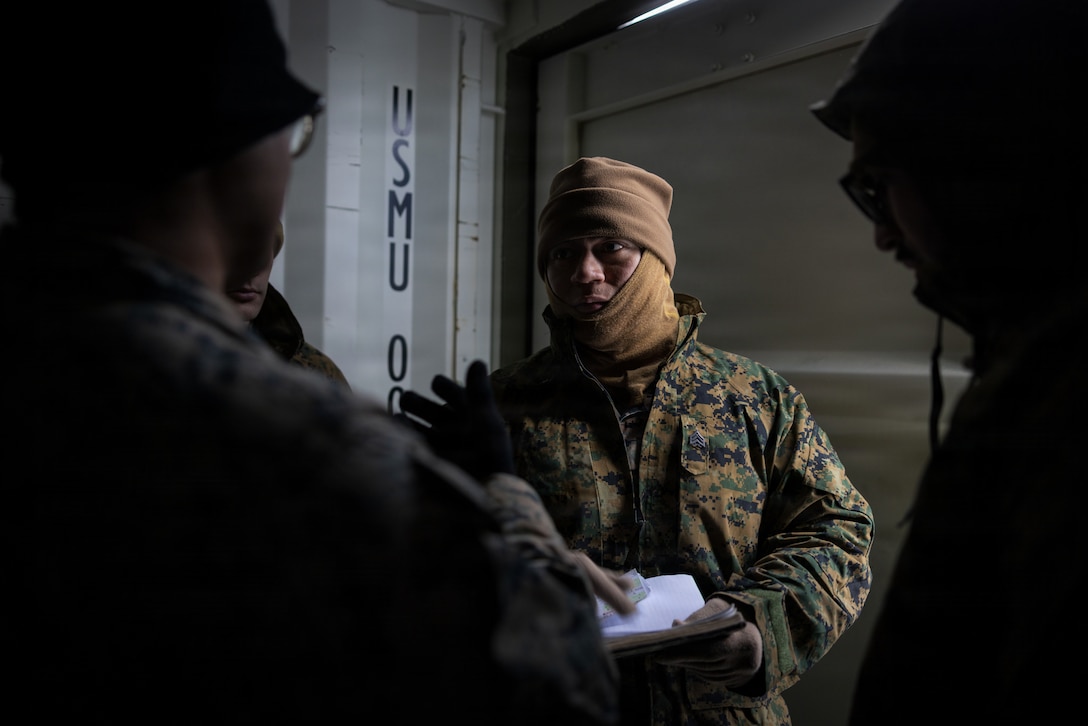 U.S. Marine Corps Sgt. Luis Perez-Velasquez, an expeditionary fuels technician with 6th Engineer Support Battalion, 4th Marine Logistics Group, Marine Forces Reserve, speaks with Marines about a plan in Elvegårdsmoen, Norway, Feb. 26, 2026. Perez-Velasquez was discussing preparations for exercise Cold Response 26. A key component of NATO's enhanced vigilance activity Arctic Sentry, exercise Cold Response 26 is a Norwegian-led winter military exercise designed to enhance collective defense capabilities and ensure U.S. readiness to rapidly deploy and seamlessly operate alongside NATO Allies in challenging arctic conditions. (U.S. Marine Corps photo by Staff Sgt. Scott Jenkins)