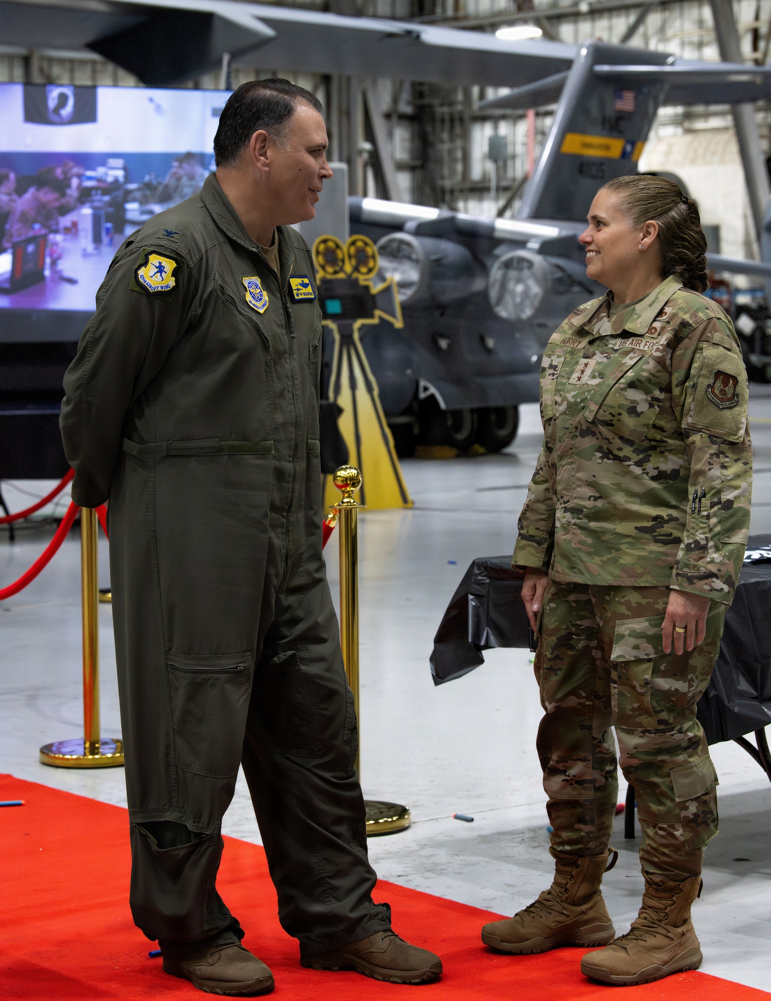 On the left, U.S. Air Force Col. Patrick McClintock, 437th Airlift Wing commander, and on the right, distinguished guest speaker, Lt. Gen. Linda Hurry, commander of the Air Force Materiel Command socialize during the 5th annual Knucklebuster Awards ceremony.