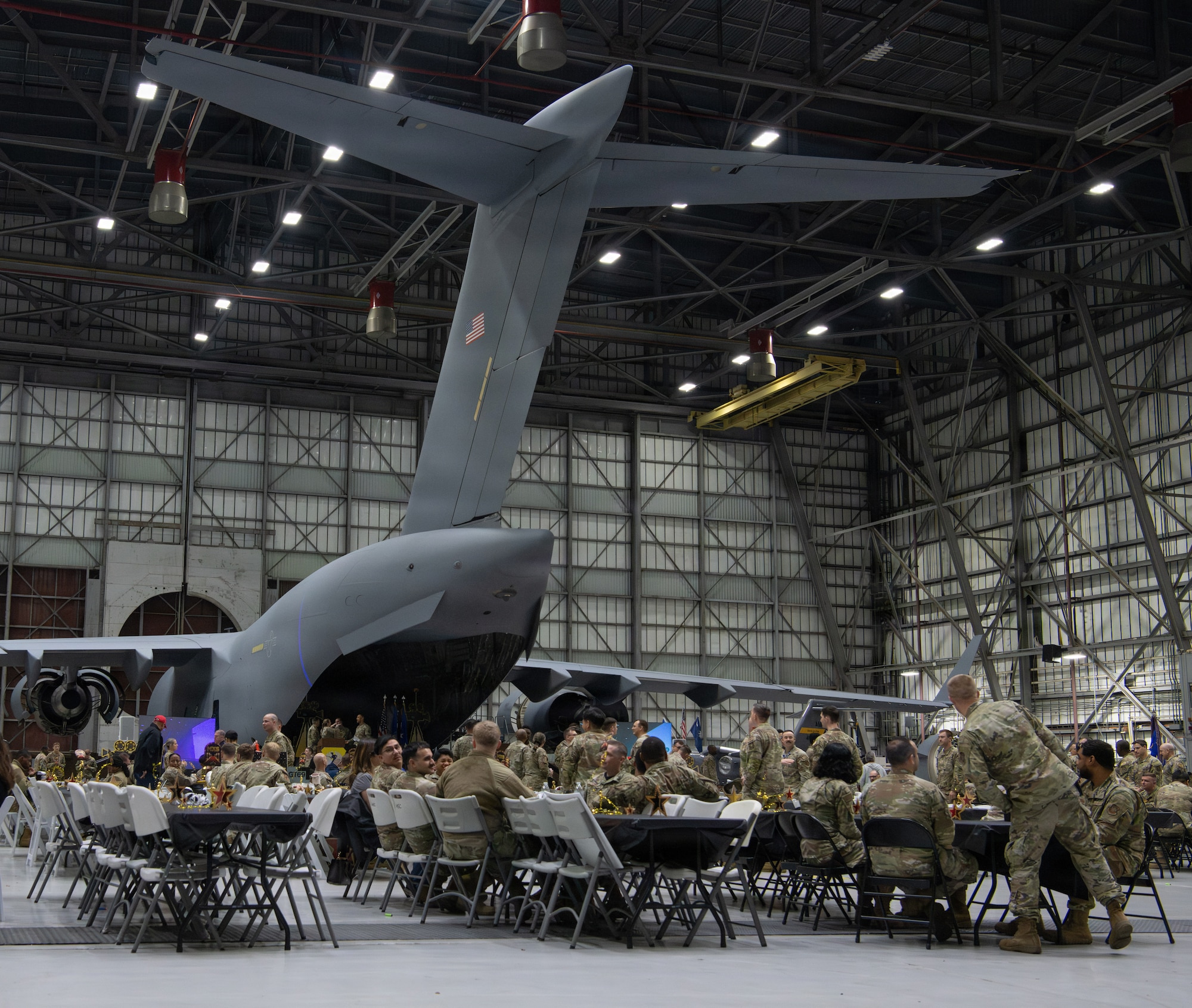 A wide shot depicting of Airmen and civilians conversing at social hour during the 5th annual Knucklebuster Awards ceremony.