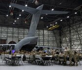A wide shot depicting of Airmen and civilians conversing at social hour during the 5th annual Knucklebuster Awards ceremony.
