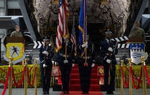 The 628th Honor Guard members line up in front of the stage to present the colors with flags at the 5th annual Knucklebuster Awards ceremony.