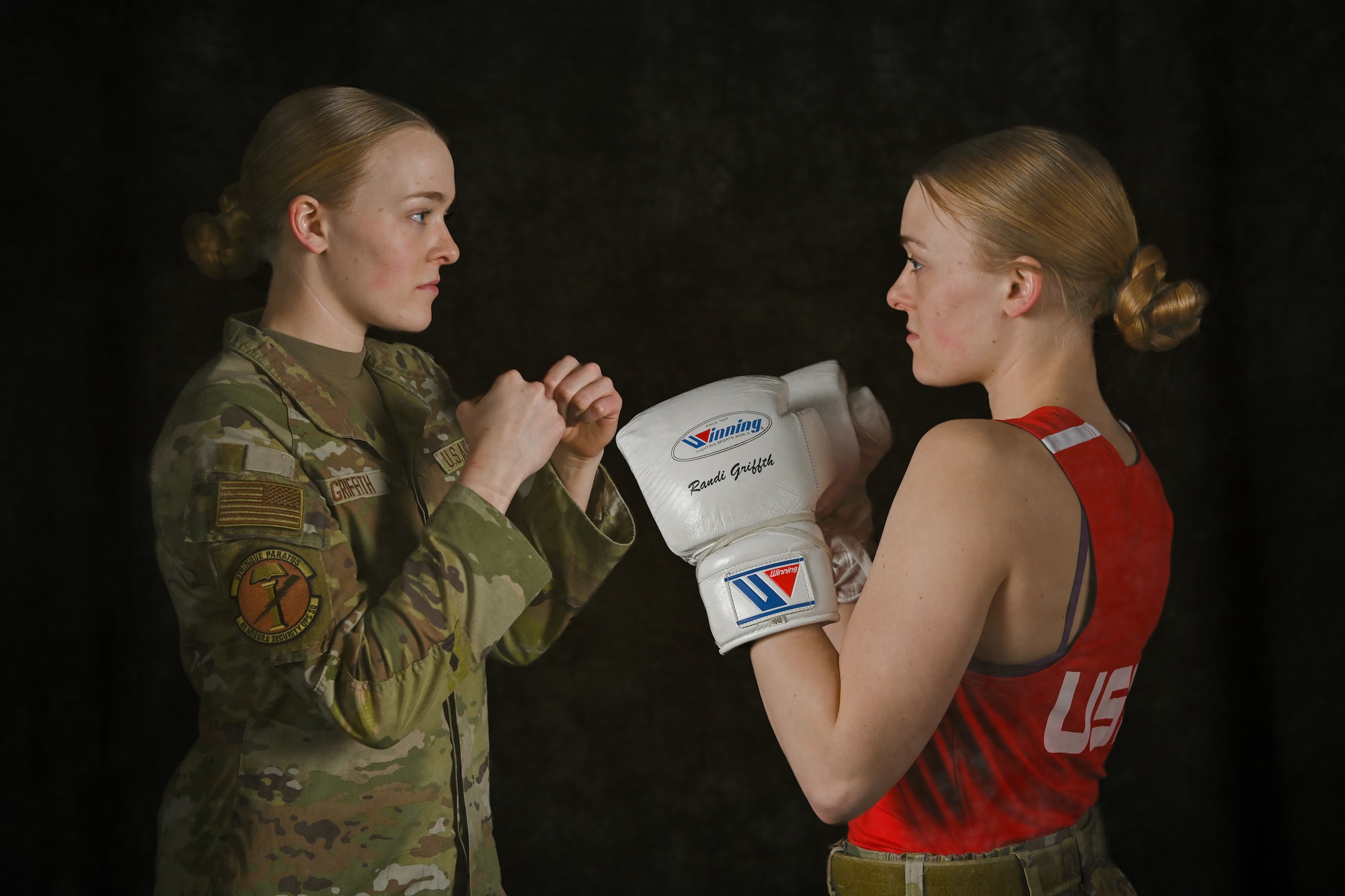 A photo illustration showing U.S. Air Force Airman 1st Class Randi Griffith, 91st Missile Security Operation Squadron tactical response force member, posing in uniform and boxing gear at Minot Air Force Base, North Dakota, Feb. 27, 2026. Griffith is a nationally competitive boxer who competed in Silver Gloves, Junior Olympic and USA Boxing national-level tournaments.