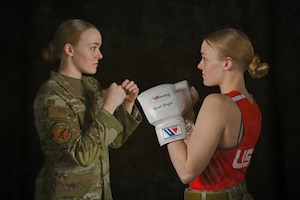 A photo illustration showing U.S. Air Force Airman 1st Class Randi Griffith, 91st Missile Security Operation Squadron tactical response force member, posing in uniform and boxing gear at Minot Air Force Base, North Dakota, Feb. 27, 2026. Griffith is a nationally competitive boxer who competed in Silver Gloves, Junior Olympic and USA Boxing national-level tournaments.