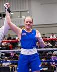 U.S. Air Force Airman 1st Class Randi Griffith, 91st Missile Security Operation Squadron tactical response force (TRF) member, raises her hand in victory during a USA Boxing match on Sept. 18, 2025. The conditioning and composure developed in the ring directly translates to her role as a TRF member.