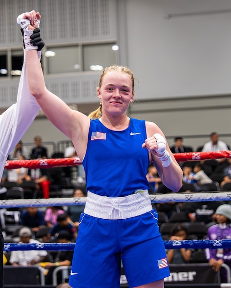 U.S. Air Force Airman 1st Class Randi Griffith, 91st Missile Security Operation Squadron tactical response force (TRF) member, raises her hand in victory during a USA Boxing match on Sept. 18, 2025. The conditioning and composure developed in the ring directly translates to her role as a TRF member.