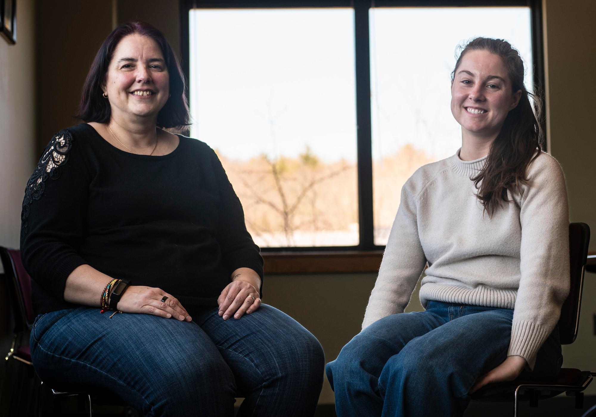 Two SAPR representatives sitting in chairs posed for the camera.