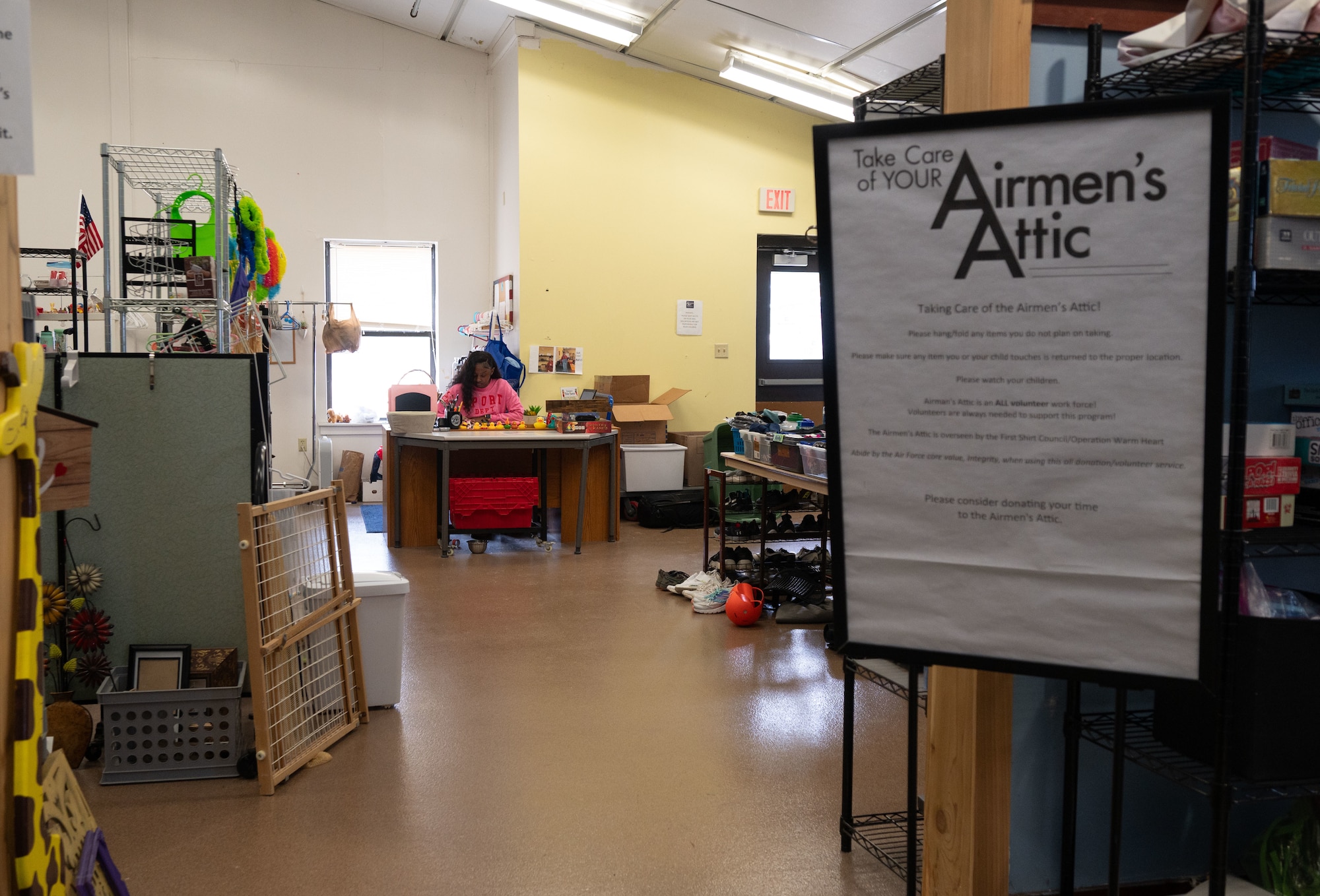 U.S. Air Force Senior Airman Tori McLeary, 436th Comptroller Squadron financial analyst, sits at the front desk of the Airmen’s Attic at Dover Air Force Base, Delaware, Feb. 21, 2026. Apart from the Airmen’s Attic, McLeary volunteers with the 436th CPTS Booster Club, Dorm Council and the Delaware USO. (U.S. Air Force photo by Airman 1st Class Liberty Kuhn)