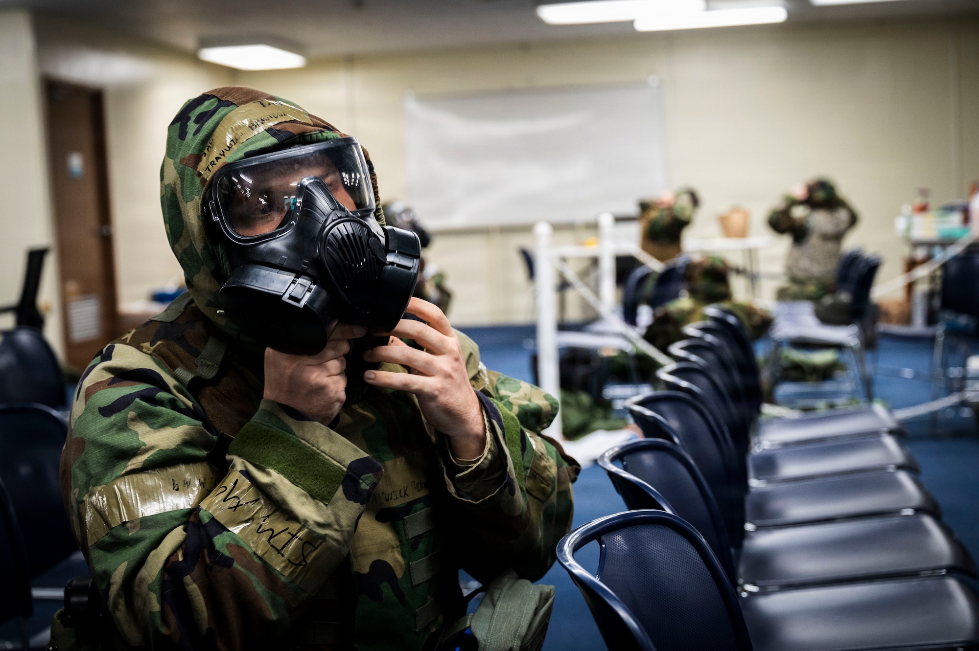 U.S. Air Force Technical Sgt. Brandon Traywick, 18th Communication Squadron non-commissioned officer in charge of radio operations, dons' mission oriented protective posture gear during U.S. Air Force-led operational exercise Beverly Midnight 26 at Kadena Air Base, Japan, March 11, 2026.