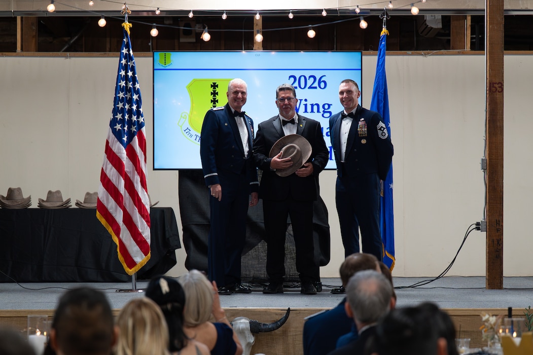 Tom Thompson, San Angelo mayor, poses for a group photo with U.S. Air Force Col. Matthew Norton, 17th Training Wing commander, and Chief Master Sgt. Derek Neill, 17th TRW command chief, during the Annual Awards ceremony at the Ft. Concho Stables, San Angelo, Texas, Feb. 27, 2026. Thompson was the guest speaker for the ceremony. (U.S. Air Force photo by Senior Airman Brian Lummus)