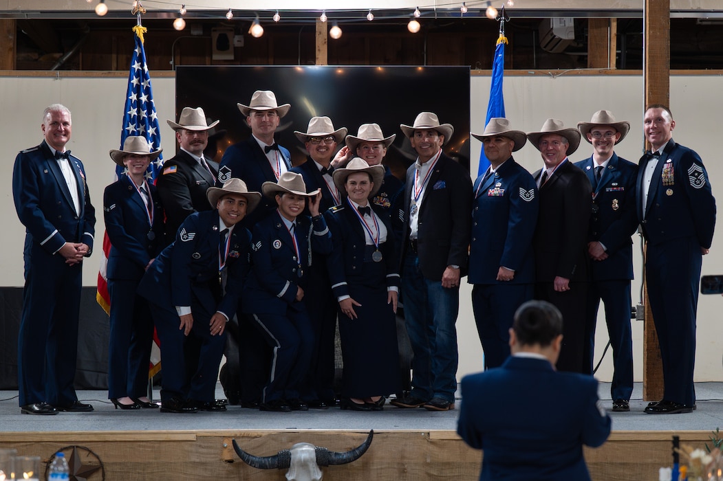 Annual Awards winners pose for a group photo with U.S. Air Force Col. Matthew Norton, 17th Training Wing commander, and Chief Master Sgt. Derek Neill, 17th TRW command chief, after the Annual Awards ceremony at the Ft. Concho Stables, San Angelo, Texas, Feb. 27, 2026. The ceremony remains a cornerstone tradition for the 17th Training Wing, reinforcing a culture of excellence and recognizing the individuals and units who set the standard for Goodfellow. (U.S. Air Force photo by Senior Airman Brian Lummus)