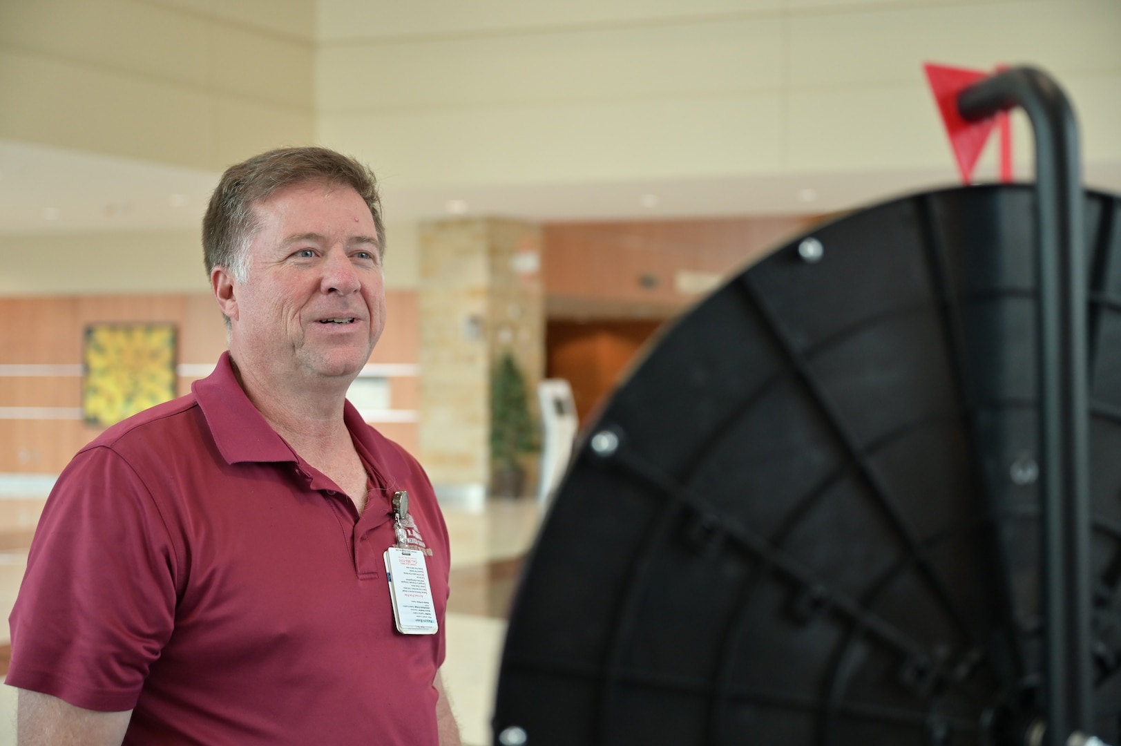 Eye on the prize: James Lanning, deputy chief of Behavioral Health, watches the trivia wheel slow to a stop. Staff and patients are asked a question based on the number it lands on, and answering correctly earns a prize during CRDAMC’s Patient Safety Week Trivia.