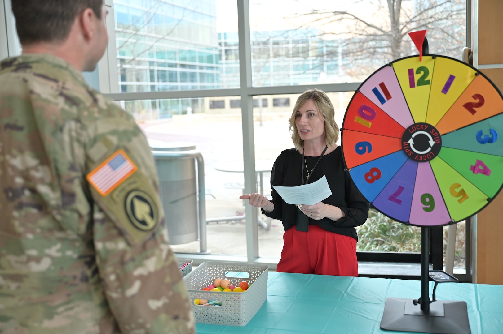 Safety in action: Heather Gilligan, patient safety manager, quizzes a participant during CRDAMC’s Patient Safety Awareness Week Trivia. The colorful numbers on the wheel decide which question is asked.