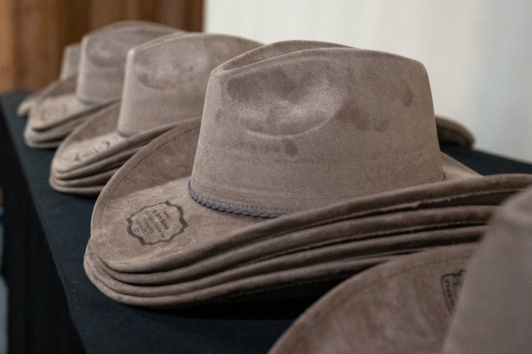 Annual Awards cowboy hats sit on a table before the Annual Awards ceremony at the Ft. Concho Stables, San Angelo, Texas, Feb. 27, 2026. The ceremony recognized individual accomplishments and fostered a sense of camaraderie and pride amongst members of the Goodfellow team.  (U.S. Air Force photo by Senior Airman James Salellas)