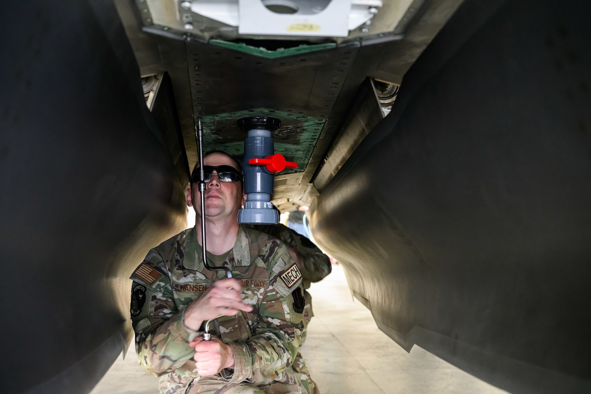 A photograph of firefighters training to extinguish battery fires on an F-35