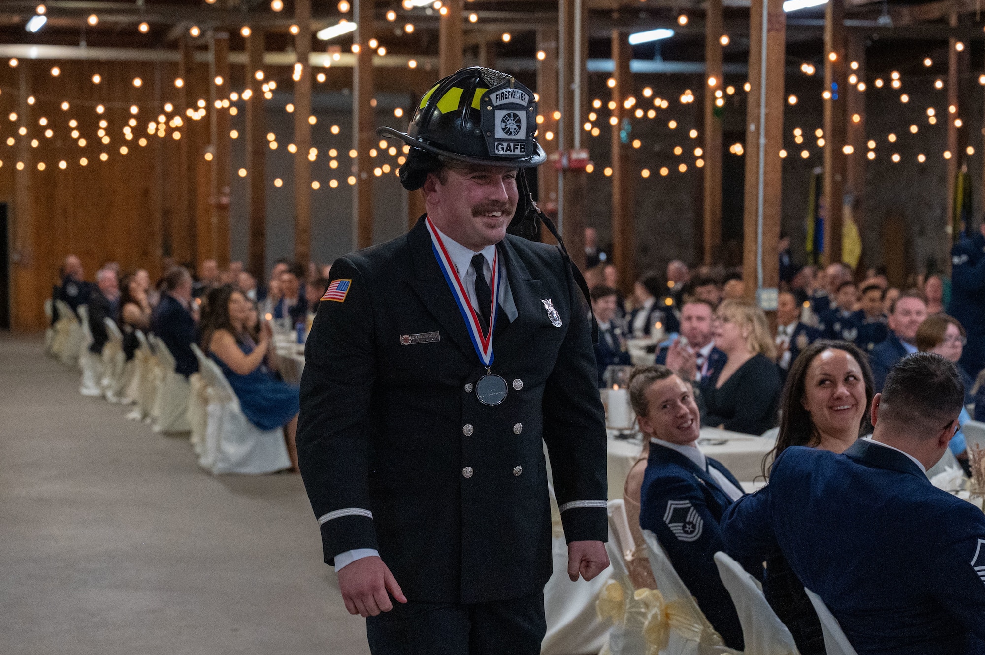 Gavin Maltais, 17th Civil Engineering Squadron firefighter, walks to the stage during the Annual Awards ceremony at the Ft. Concho Stables, San Angelo, Texas, Feb. 27, 2026. Maltais was the Civilian Non-Supervisory Category I of the Year award winner. (U.S. Air Force photo by Senior Airman James Salellas)
