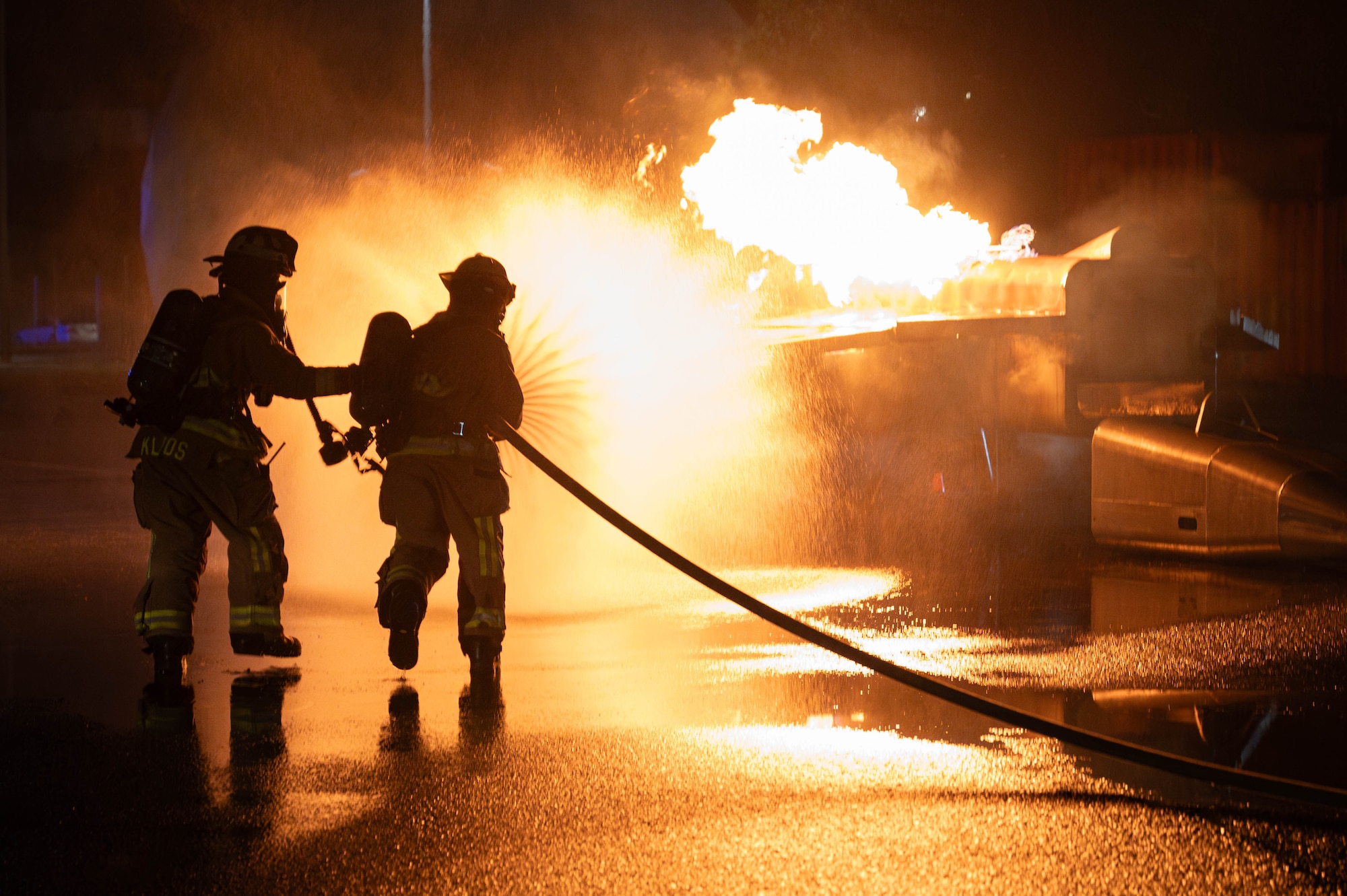 U.S. Air Force 18th Civil Engineer Squadron firefighters extinguish a simulated aircraft fire during U.S. Air Force-led operational exercise, Beverly Midnight 26 at Kadena Air Base, Japan, March 12, 2026. BM26 enhances U.S. interoperability by fostering an exchange of information and refining shared tactics, techniques and procedures to better integrate defense capabilities in support of regional security. (Photo by U.S. Air Force Airman 1st Class Nathaniel Jackson)