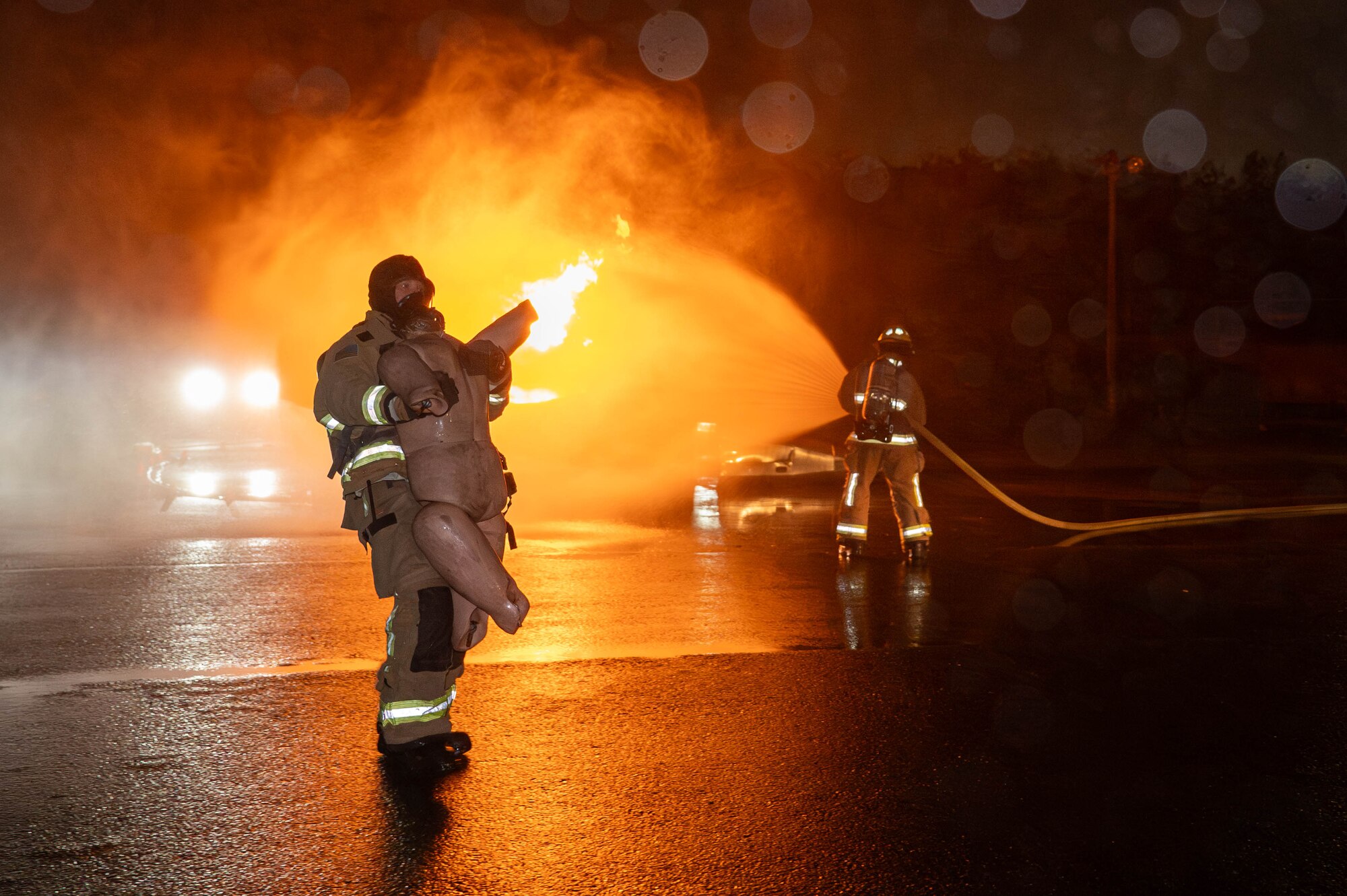 A U.S. Air Force 18th Civil Engineer Squadron firefighter rescues a simulated pilot from a simulated aircraft on fire, during U.S. Air Force-led operational exercise, Beverly Midnight 26 at Kadena Air Base, Japan, March 12, 2026. This exercise tested rapid response capabilities to prepare our firefighters for potential emergencies in the Indo-Pacific region. (Photo by U.S. Air Force Airman 1st Class Nathaniel Jackson)