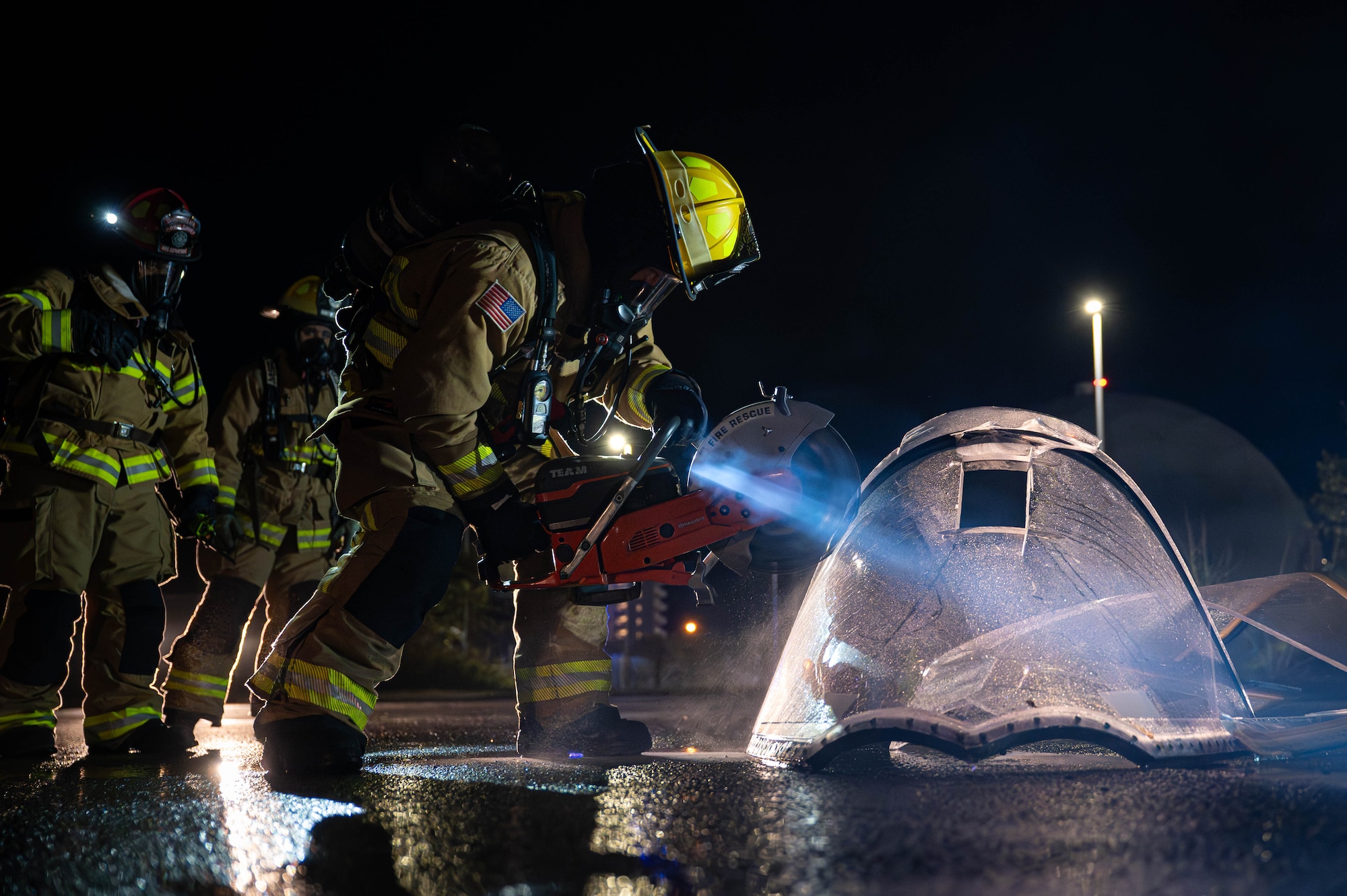 A U.S. Air Force 18th Civil Engineer Squadron firefighter cuts into a simulated aircraft canopy during U.S. Air Force-led operational exercise, Beverly Midnight 26 at Kadena Air Base, Japan, March 12, 2026. This exercise tested rapid response capabilities to prepare our firefighters for potential emergencies in the Indo-Pacific region. (Photo by U.S. Air Force Airman 1st Class Nathaniel Jackson)